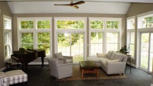New home addition with sofas and piano - general contractors auburn nh