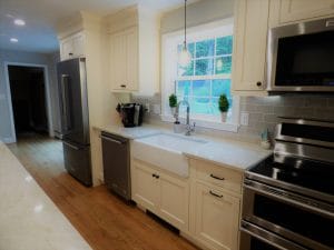 Beautiful tile backsplash and farmers sink with granite tops - kitchen renovations atkinson nh