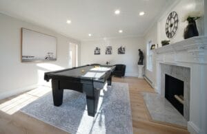 Remodeled living room with pool table - general contractors auburn nh